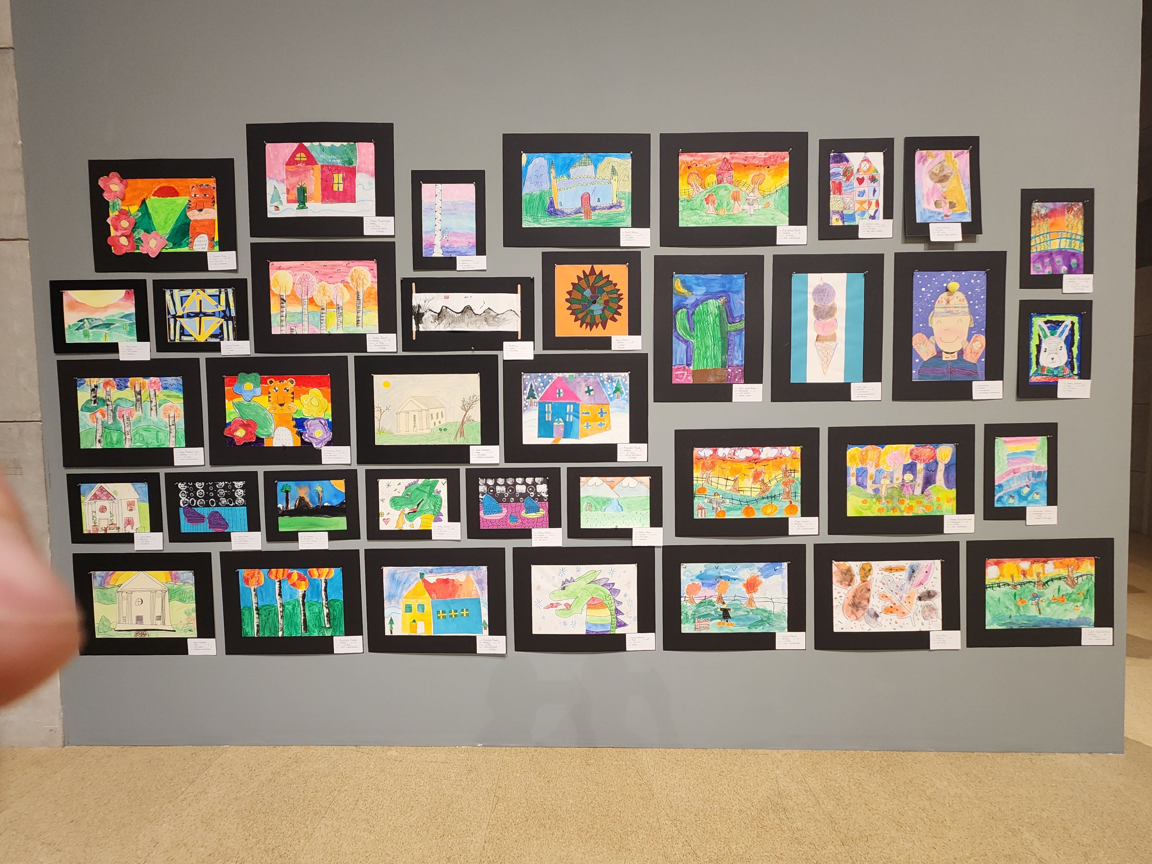 Various pieces of student artwork on display at the gallery
